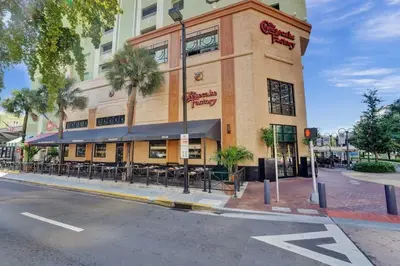a building on the corner of a street with a restaurant at Rustic Retreats Cozy 1BR For 4 Guests In The Heart Of Fort Lauderdale in Fort Lauderdale