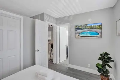 a white room with a couch and a painting on the wall at Rustic Retreats Beachy 1BR for 4 guests in the heart of Fort Lauderdale in Fort Lauderdale
