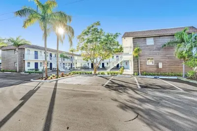 an empty parking lot in front of a building at Rustic Retreats Beachy 1BR for 4 guests in the heart of Fort Lauderdale in Fort Lauderdale