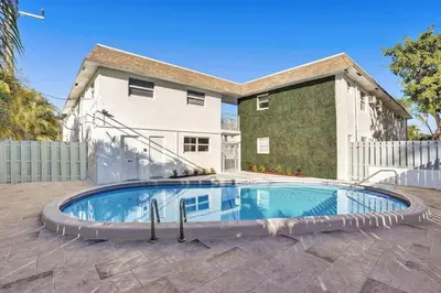 a swimming pool in front of a house at Rustic Retreats Beachy 1BR for 4 guests in the heart of Fort Lauderdale in Fort Lauderdale