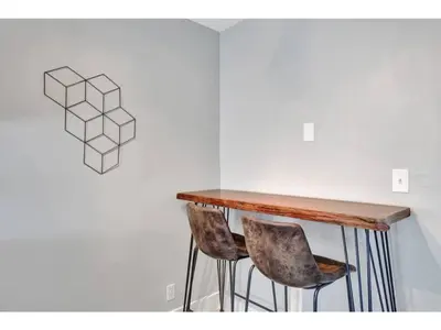a table and two chairs in front of a wall at Rustic Retreats Modern 1BR for 2 guests in the heart of Fort Lauderdale in Fort Lauderdale