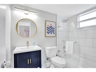 a bathroom with a toilet and a sink and a mirror at Rustic Retreats Beachy 1BR for 4 guests in the heart of Fort Lauderdale in Fort Lauderdale