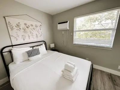 a bedroom with a white bed with towels on it at Rustic Retreats Cozy 1BR for 4 guests minutes from Las Olas in Fort Lauderdale