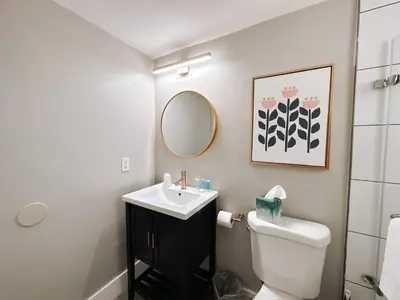a bathroom with a sink and a toilet and a mirror at Rustic Retreats Cozy 1BR For 4 Guests Minutes From Las Olas in Fort Lauderdale