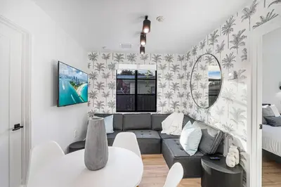 a living room with a couch and a table at Lux Retreat By Renzzi in Miami