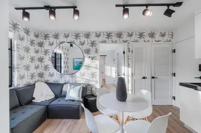 a living room with a blue couch and a table at Lux Retreat By Renzzi in Miami