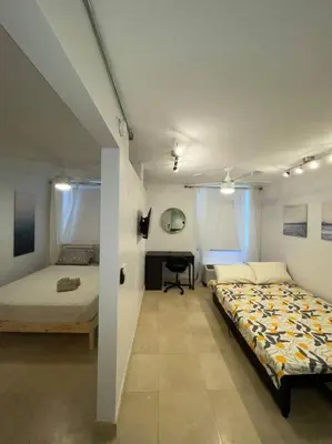a bedroom with two beds and a desk in it at South Beach Escape in Miami Beach