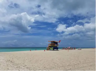 a lifeguard stand on a beach with people on it at South Beach Escape in Miami Beach