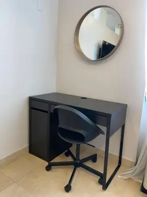 a black desk with a chair and a mirror at South Beach Escape in Miami Beach