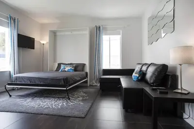 a living room with a bed and a couch at Miami Beach Getaway 100 yards from Beach in Miami Beach