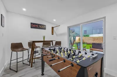 a living room with a chess board on a table at Modern villa in Design District ! in Miami
