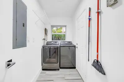 a kitchen with a washer and dryer in a room at Modern villa in Design District ! in Miami