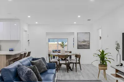 a living room with a blue couch and a table at Modern villa in Design District ! in Miami