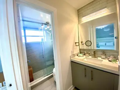 a bathroom with a shower and a sink and a mirror at Panoramic luxurious waterfront one bedroom apartment with Miami skyline view Free parking 5min drive to Miami Beach in Miami Beach