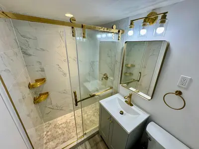 a bathroom with a shower and a sink and a mirror at Directly on the Beach with Pool & Parking in Miami Beach
