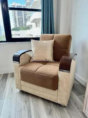 a brown couch in a living room with a window at Directly on the Beach with Pool & Parking in Miami Beach