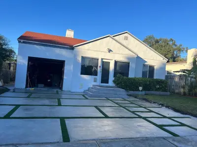 a white house with a driveway at Cozy room in a quiet home in Miami