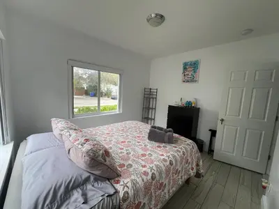 a bedroom with a bed and a window at Cozy room in a quiet home in Miami