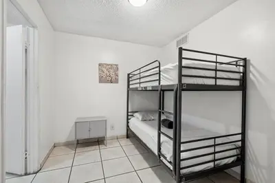 a bedroom with two bunk beds in a room at Crocodhouse early check in eight years hosting in Fort Lauderdale