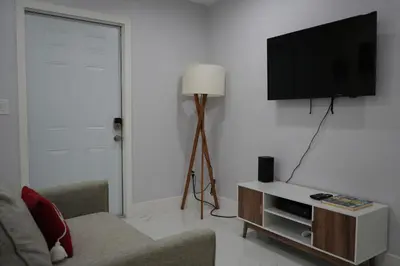 a living room with a tv and a couch at Charming two bedroom apartment. in Miami