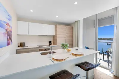 a kitchen with a white counter and a large window at Costa Hollywood Beach in Hollywood