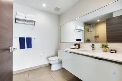 a white bathroom with a toilet and a sink at Costa Hollywood Beach in Hollywood