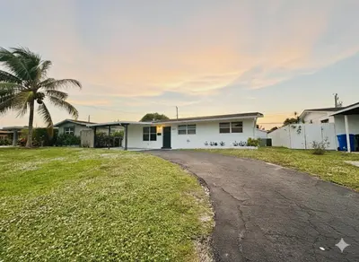 a house with a palm tree and a driveway at Private Pool Villa Tropical Retreat Near Beach in Fort Lauderdale