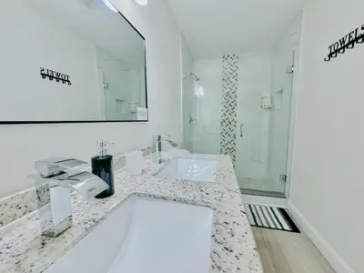 a white bathroom with a sink and a shower at Private Pool Villa Tropical Retreat Near Beach in Fort Lauderdale