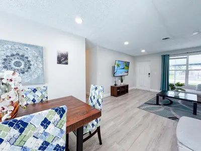 a dining room with a table and chairs and a television at Private Pool Villa Tropical Retreat Near Beach in Fort Lauderdale