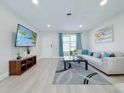 a living room with a couch and a table at Private Pool Villa Tropical Retreat Near Beach in Fort Lauderdale