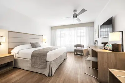 a hotel room with a bed and a desk at Riu Plaza Miami Beach in Miami Beach