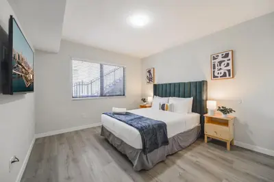 a bedroom with a large bed and a window at Prime Location Apt on Calle Ocho in Little Havana in Miami