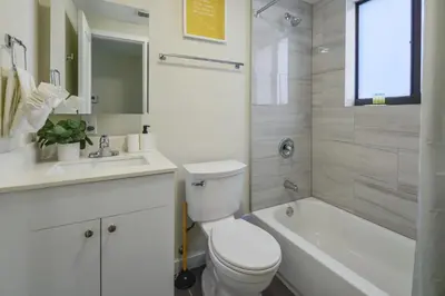 a bathroom with a toilet and a tub and a sink at Prime Location Apt on Calle Ocho in Little Havana in Miami