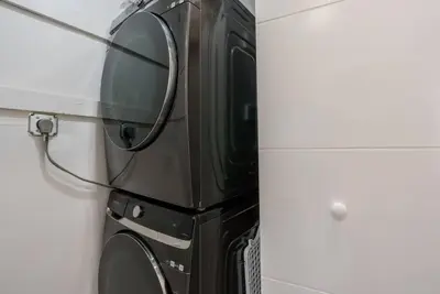 a black microwave sitting on top of a refrigerator at New! Miami & Calle Ocho Simpson's Funhouse! in Miami