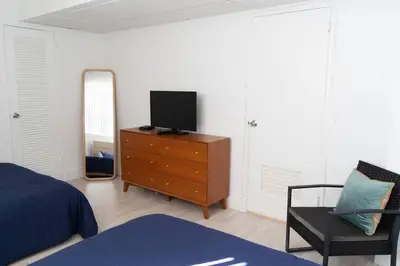 a bedroom with a television on a dresser with a mirror at Apartment on the beach Tides Hollywood Beach 5th floor U in Hollywood