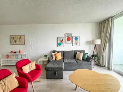 a living room with a gray couch and red chairs at Apartment on the beach Tides Hollywood Beach 5th floor U in Hollywood
