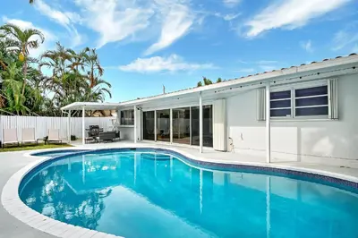 a swimming pool in front of a house at Casa Azul 4Bed 2Bath Home with Heated Pool & Spa 1304 in Hollywood