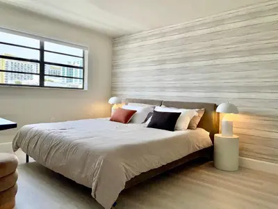 a bedroom with a large bed with two lamps at Zen Vibe on the Beach /700 SqFt in Miami Beach