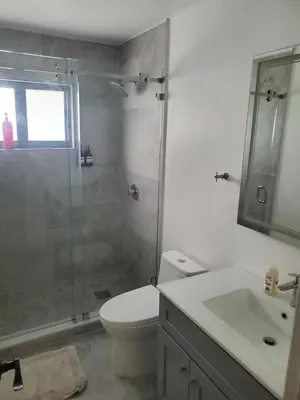a bathroom with a shower and a toilet and a sink at Cozy family home in quiet area, nice garden views. in Tamiami
