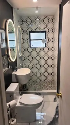 a bathroom with a white toilet and a sink at Paradise Gardens-Wilton Manors- Male only in Fort Lauderdale
