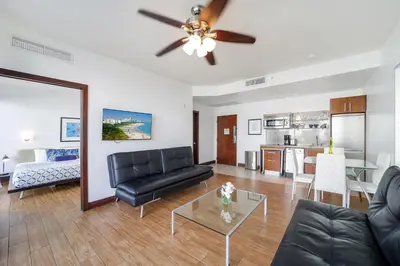 a living room with a couch and a table at Strand Ocean Drive Suites in Miami Beach