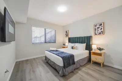 a bedroom with a large bed and a television at Heart of Little Havana Awaits in Miami
