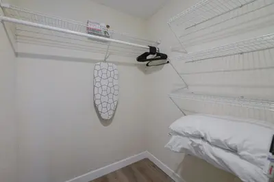 a white room with a bed and a whiteolin at Heart of Little Havana Awaits in Miami