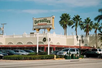 a sign in front of a car center at Heart of Little Havana Awaits in Miami