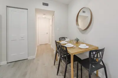 a dining room with a table and a mirror at Apartment in Calle Ocho a Slice of Little Havana in Miami