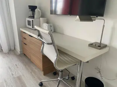 a white desk with a computer and a microwave at Smart Stay Near the Ocean 2Full Beds Beach Studio in Hallandale Beach