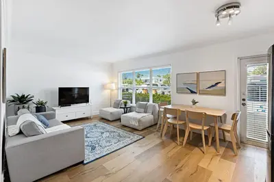 a white living room with a table and a couch at Beach Apt with Waterview in Las Olas Blvd in Fort Lauderdale