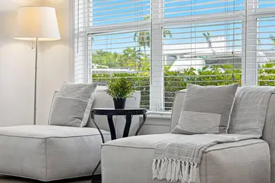 a living room with two chairs and a window at Beach Apt with Waterview in Las Olas Blvd in Fort Lauderdale