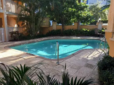 a swimming pool in the middle of a yard at Beach Apt with Waterview in Las Olas Blvd in Fort Lauderdale