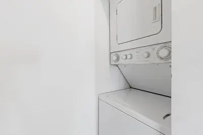 a kitchen with a microwave and a washer and dryer at Las Olas Blvd Exclusive Apt with waterview in Fort Lauderdale